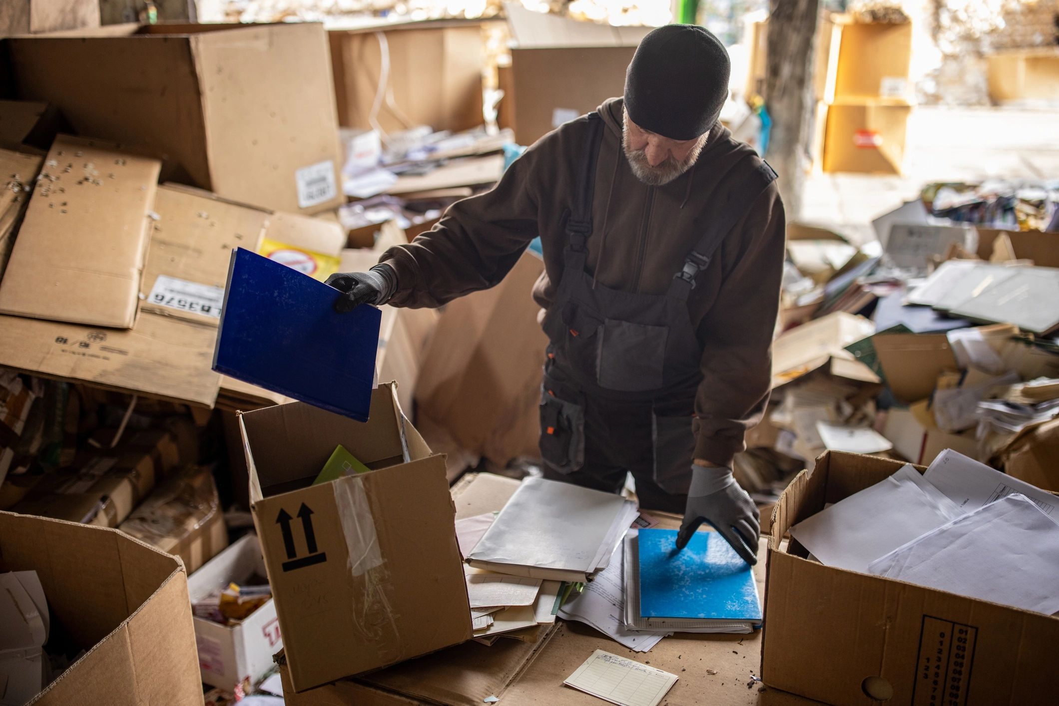 Worker sorting items responsibly for recycling and disposal